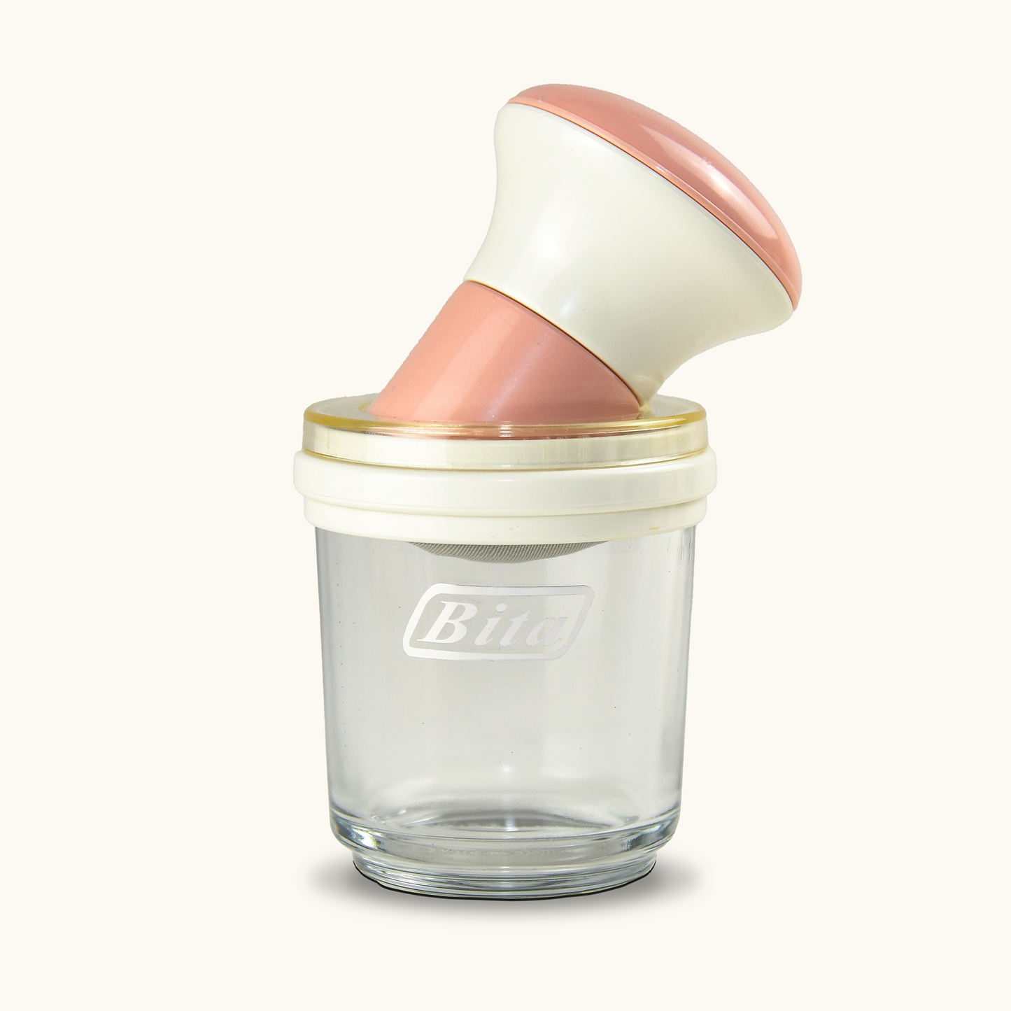 طحانة عجيبة متعددة الاستخدامات بطراز عصري، تتكون من وعاء زجاجي شفاف مع غطاء محكم ومقبض مريح باللونين الأبيض والوردي، مصممة لطحن الزعفران والتوابل بسهولة وكفاءة.